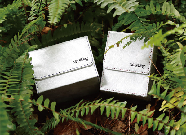 Sanseking card protection products surrounded by green ferns