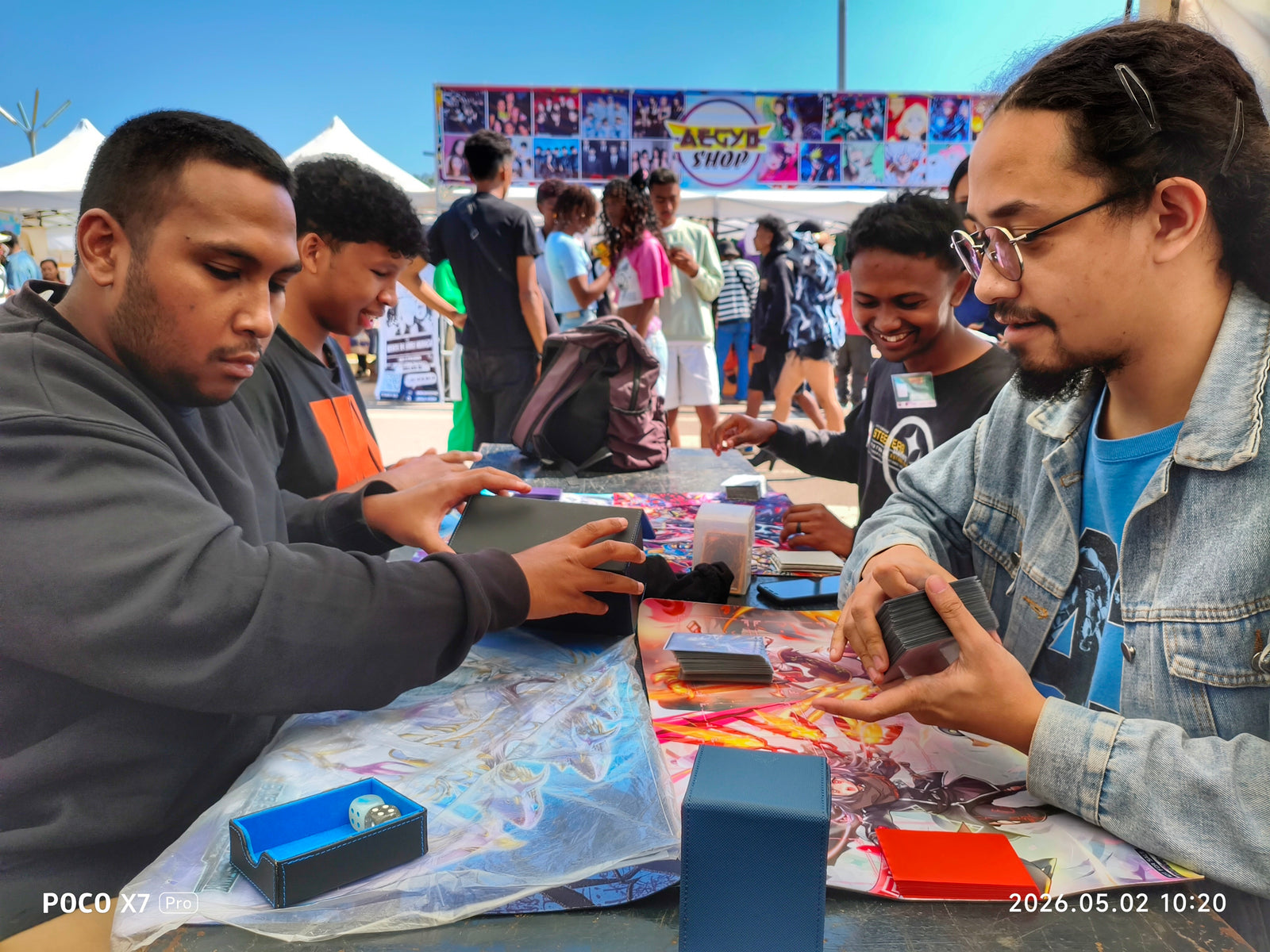 Trading card players using Sanseking accessories at a community event